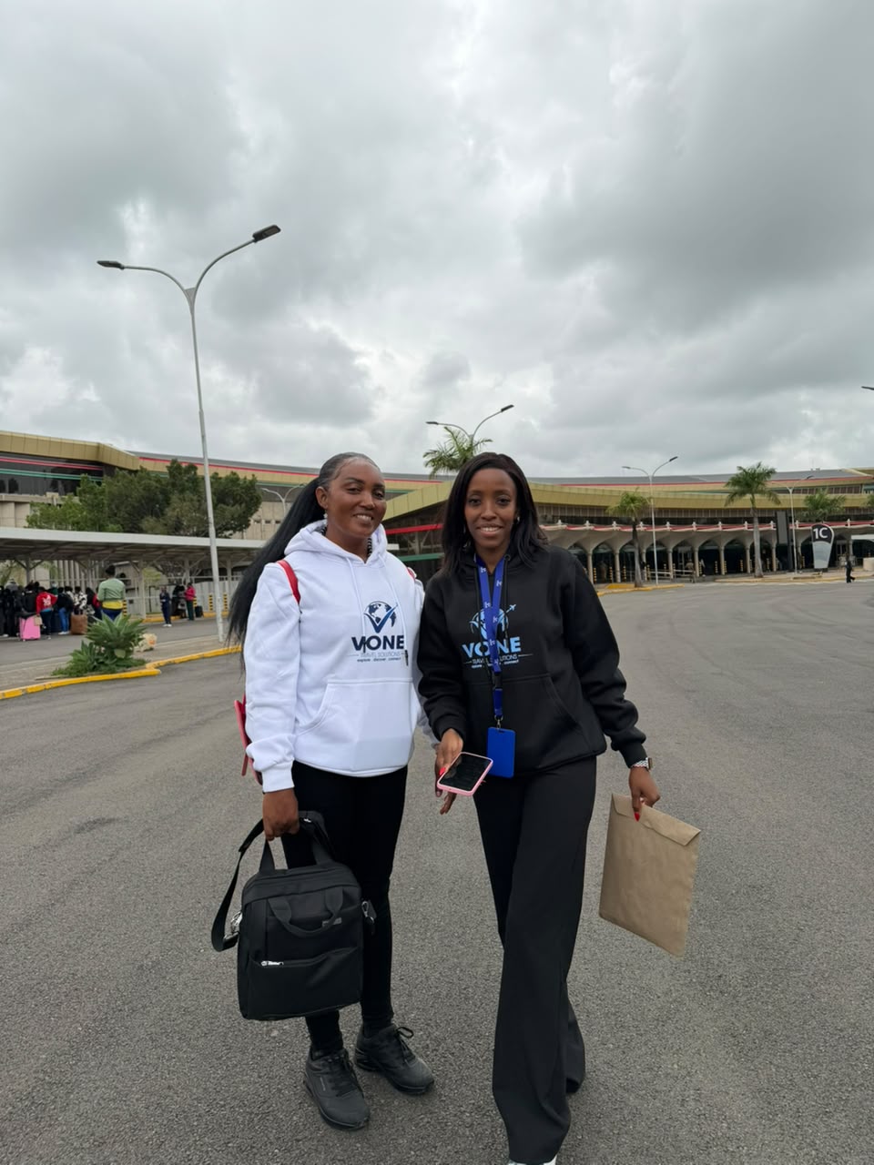 Vone Travel Solutions staff with a client at the airport